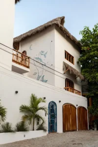 Bathed in warm sun, a guest finds stillness in sky-flow yoga — uplifting self-care inside a Mexican Riviera self-care hotel.