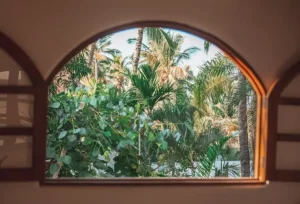 Guest floats in woven craft-made hammock during suspended yoga — a breezy wellness moment at one of the best Sayulita resorts.