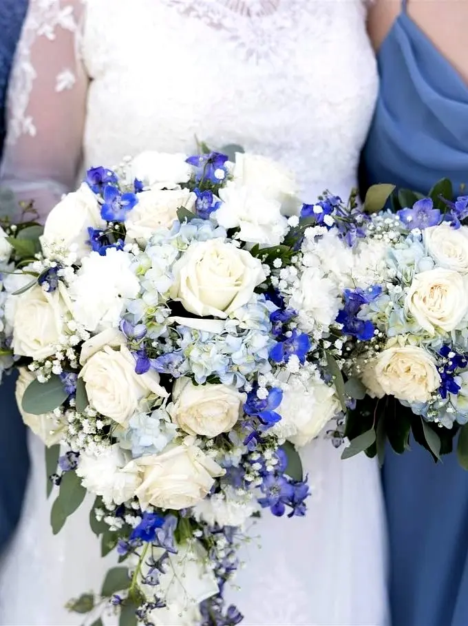 A bride’s bouquet glows beside the sea — romance blooms in an exclusive courtyard setting — perfect for a destination wedding venue.