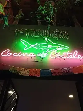 Neon reflections and seafood aromas fill El Tiburón’s bar in downtown Sayulita — a breezy night on the Pacific Riviera.