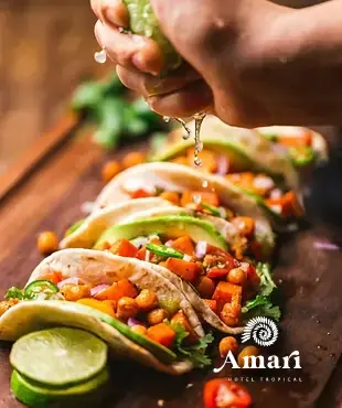 Lemon squeezed over fresh fish tacos at Amari — authentic Mexican flavors and relaxed boutique hotel dining in Sayulita.