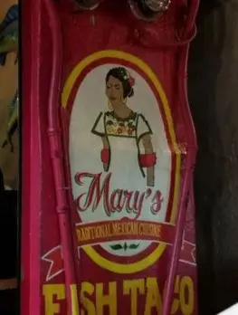 A bright Mary’s Traditional Mexican Cuisine sign features a painted woman in embroidered dress, highlighting this beloved spot by Sayulita’s plaza