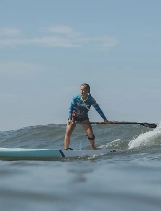 A paddleboarder glides across tranquil Pacific waters under soft sunrise—morning grace on the Riviera Nayarit Ocean Journey.