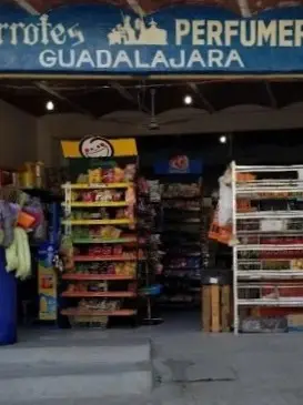 Open shelves stocked with snacks, drinks, and household items sit near the entrance of a small neighborhood grocery store in Sayulita.