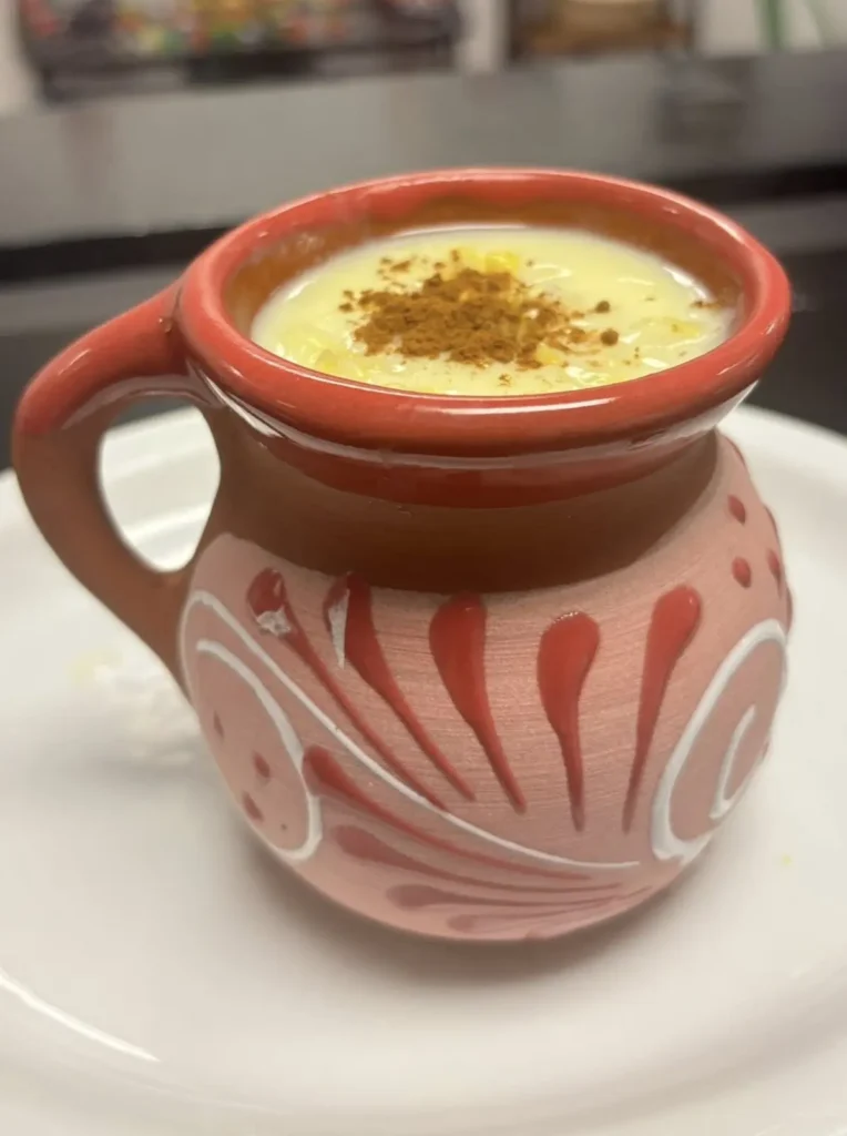 Warm atole with cinnamon and maize served each November reflects a beloved Mexican tradition near Sayulita’s surf beaches during Día de Muertos.