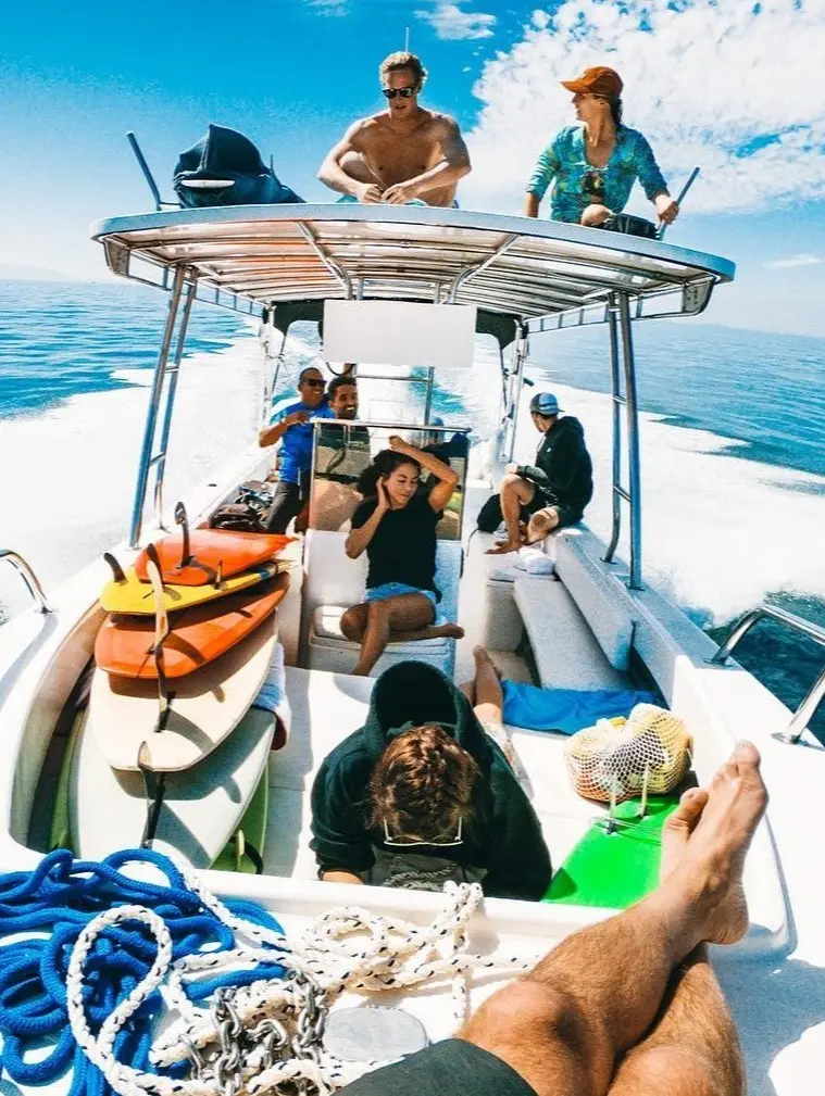 Friends enjoy a bright day exploring open water, where clear turquoise waves and warm sunlight shape the lively rhythm of a sunny ocean outing.