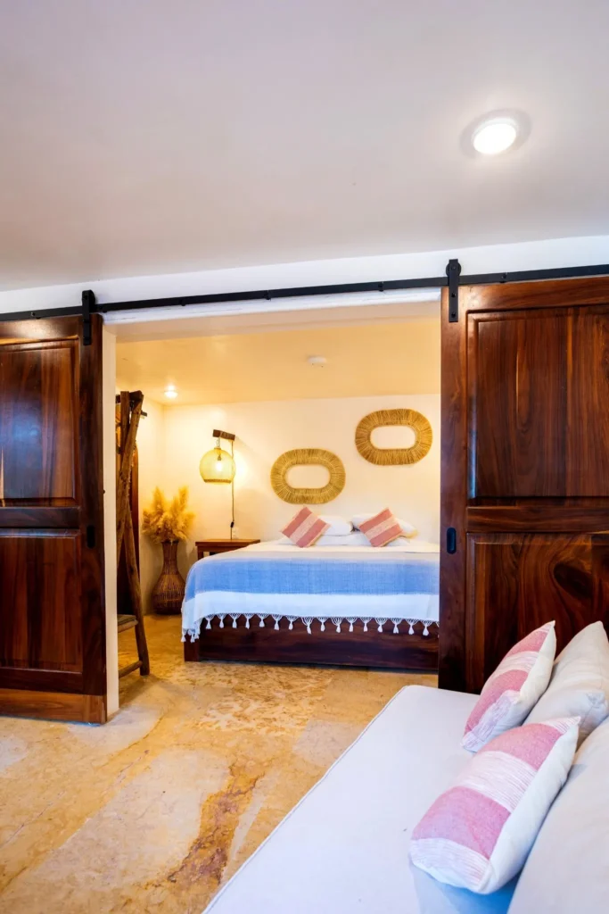 A welcoming bedroom at Amari features natural shoreline accents, warm wood tones, soft textiles, and calming details designed for rest and easy living.