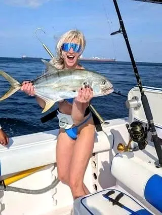 A crevalle jack rests on a panga deck, its thick body showing metallic silver tones that highlight the strength of nearshore sport fishing.