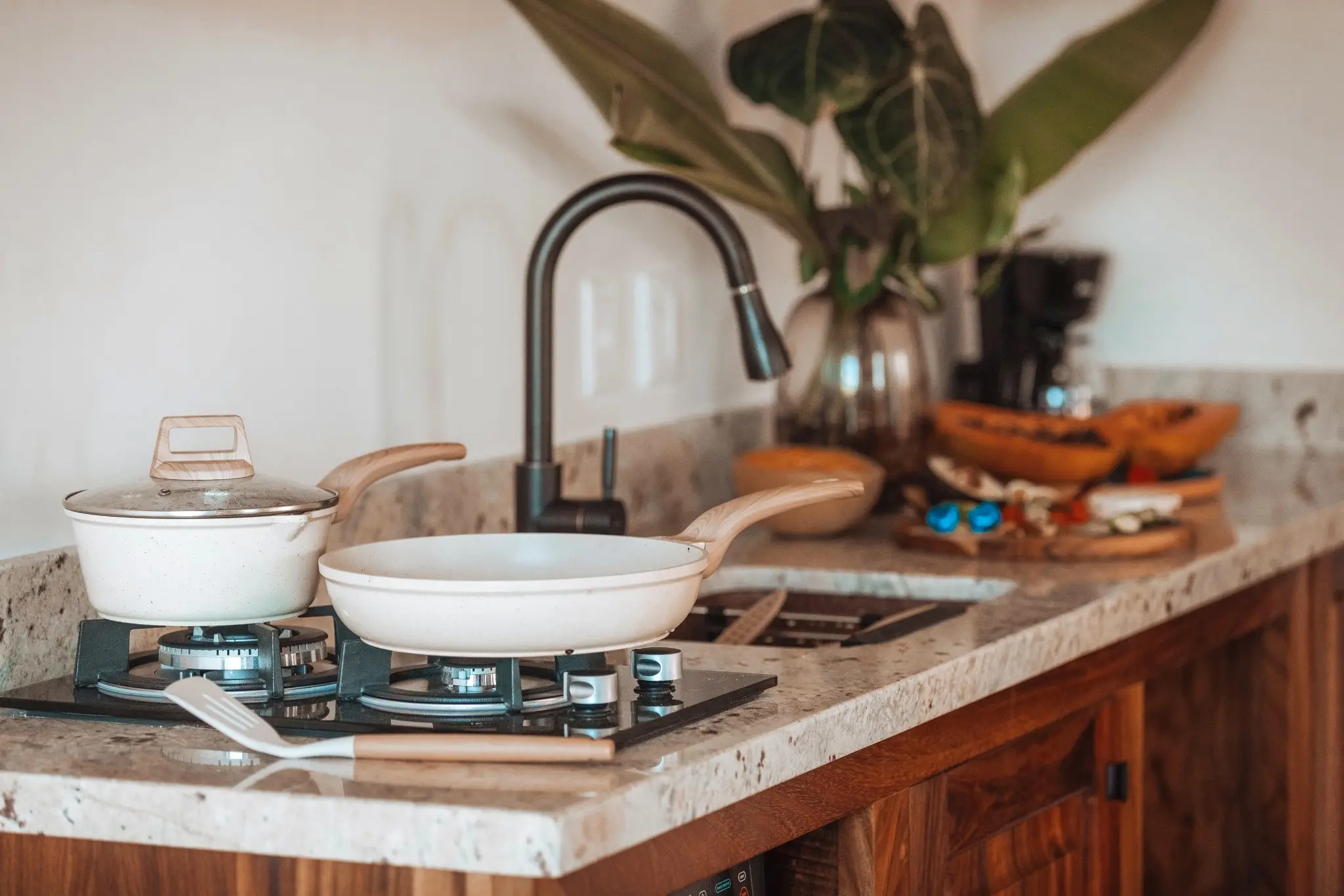Full Kitchen With Gas Stove, Stone Countertops, and Coffee Station