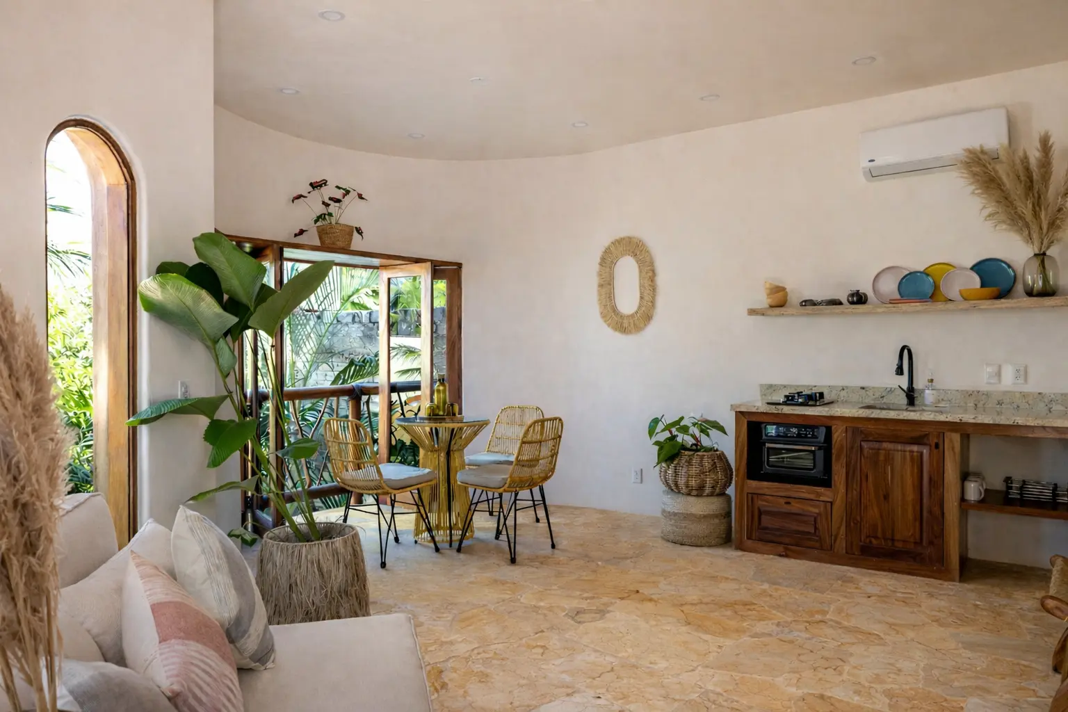 Open-Concept Living Space With Full Kitchen, Dining Table, and Tropical Views