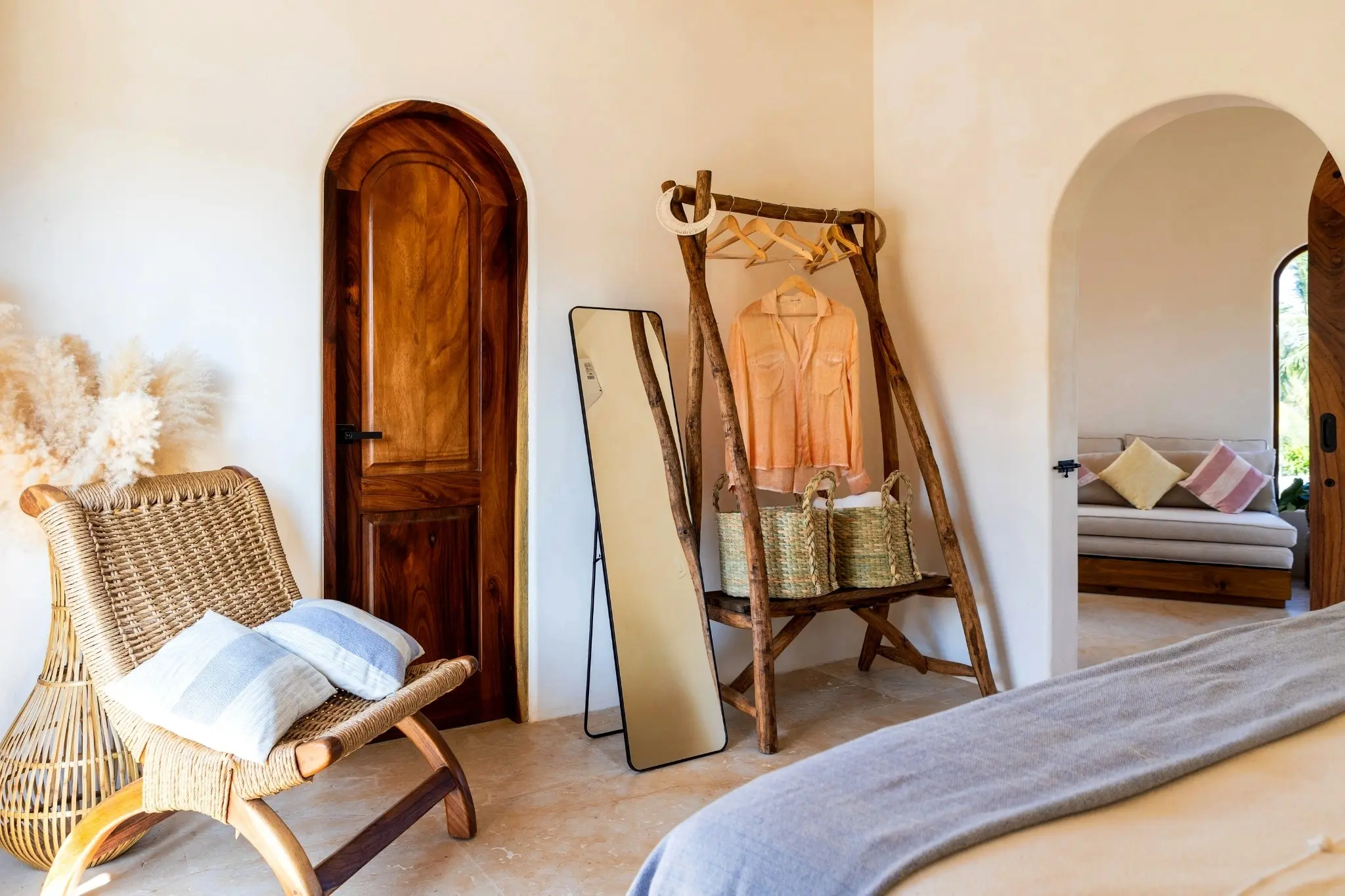 Bedroom Entry With Rustic Wardrobe Rack, Full-Length Mirror, and Woven Accents