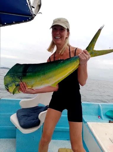 A dorado is held on a boat along Mexico’s Pacific coast, capturing the relaxed experience travelers enjoy when booking fishing trips from Sayulita.