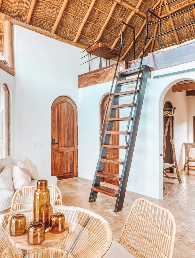Airy lounge with native doors and arched detailing frames a workspace at Amari — an eco-aware spa retreat in Riviera Nayarit.