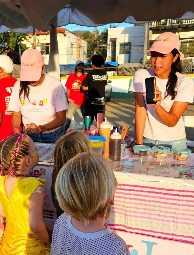 Children gather at an ice-cream cart as during Sayulita’s lively family festival, adding fun moments to a stay at Sayulita’s beachfront hotels.