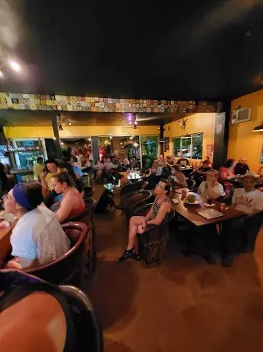 Restaurant crowd in Sayulita with locals and visitors listening to live music and evening entertainment in a festive atmosphere after dark.