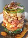 Layered mariscos tower at Matiz with shrimp, tomato, avocado, and red onion in a citrus–chile dressing, known for bright flavor and generous portions.