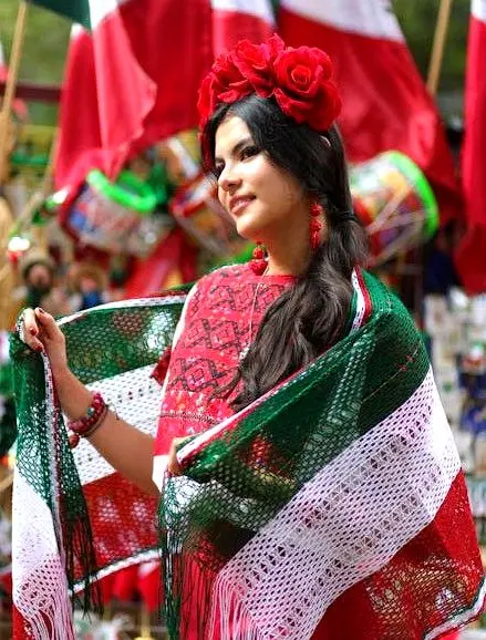 A woman in red roses and embroidered shawl captures Mexico’s proud spirit during Sayulita’s colorful festive season on the Nayarit Coast.