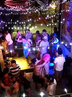 Couples sway to lively salsa rhythms creating a warm Semana Santa atmosphere filled with music, connection, and festive nighttime energy.