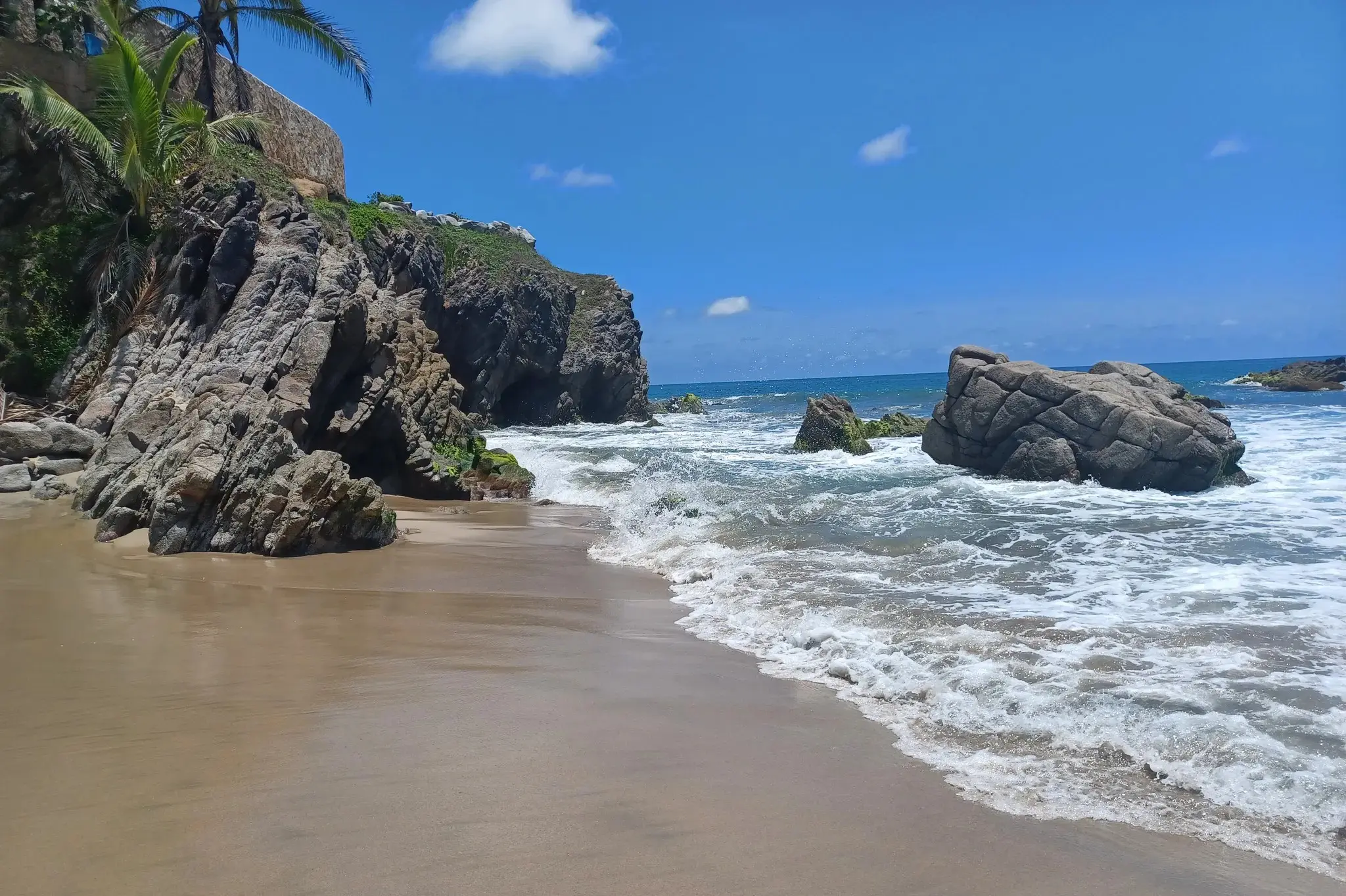 Foam and spray rise where waves strike Pátzcuaro’s cliffs—a breathtaking display of the Pacific’s might along Mexico’s Riviera Coast.
