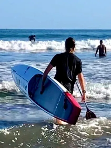 Paddleboarders cut across sunrise waves under open skies — Sayulita’s summer celebration along the Nayarit Coast.