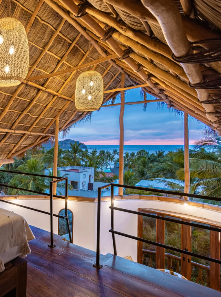 The palapa penthouse at Amari Boutique Hotel features custom wood details, open design, and elevated shoreline views that create a relaxed stay.