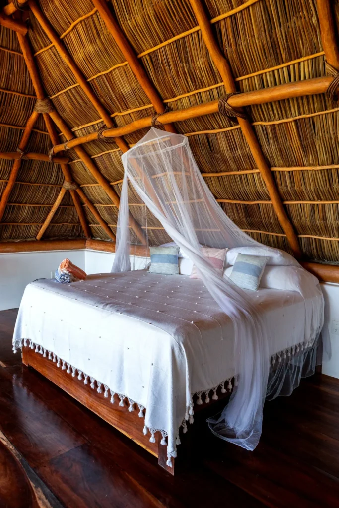 A serene Amari palapa bedroom featuring a custom bed and warm natural textures that create a relaxing, breezy retreat for restful nights.