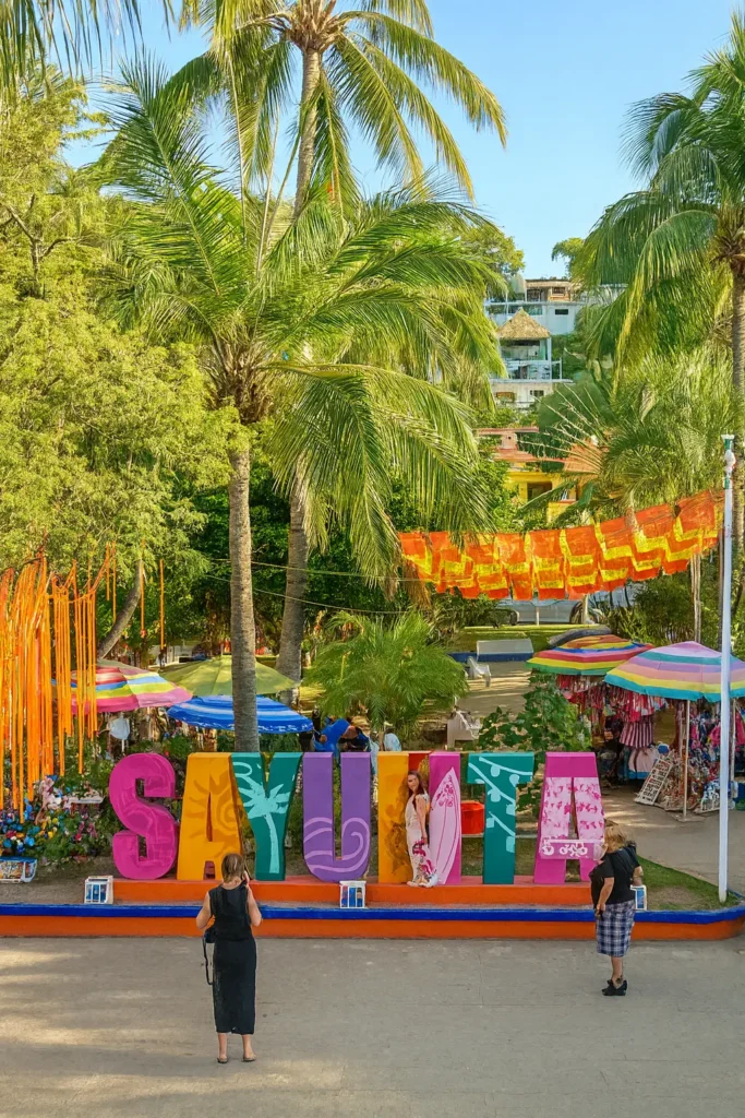 Palm shade and papel picado surround the Sayulita plaza, where locals and visitors connect in a warm community that builds confidence and trust.