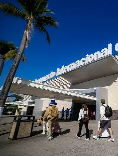 Travelers step into warm sunlight outside Puerto Vallarta Airport before heading north to Sayulita, a colorful village near Mexico’s Pacific Riviera.