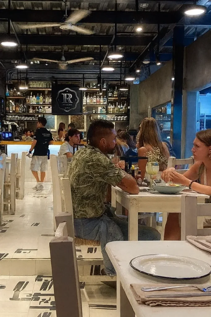 A lively Sayulita restaurant scene with guests enjoying dinner in a relaxed coastal atmosphere that highlights the town’s vibrant dining culture.