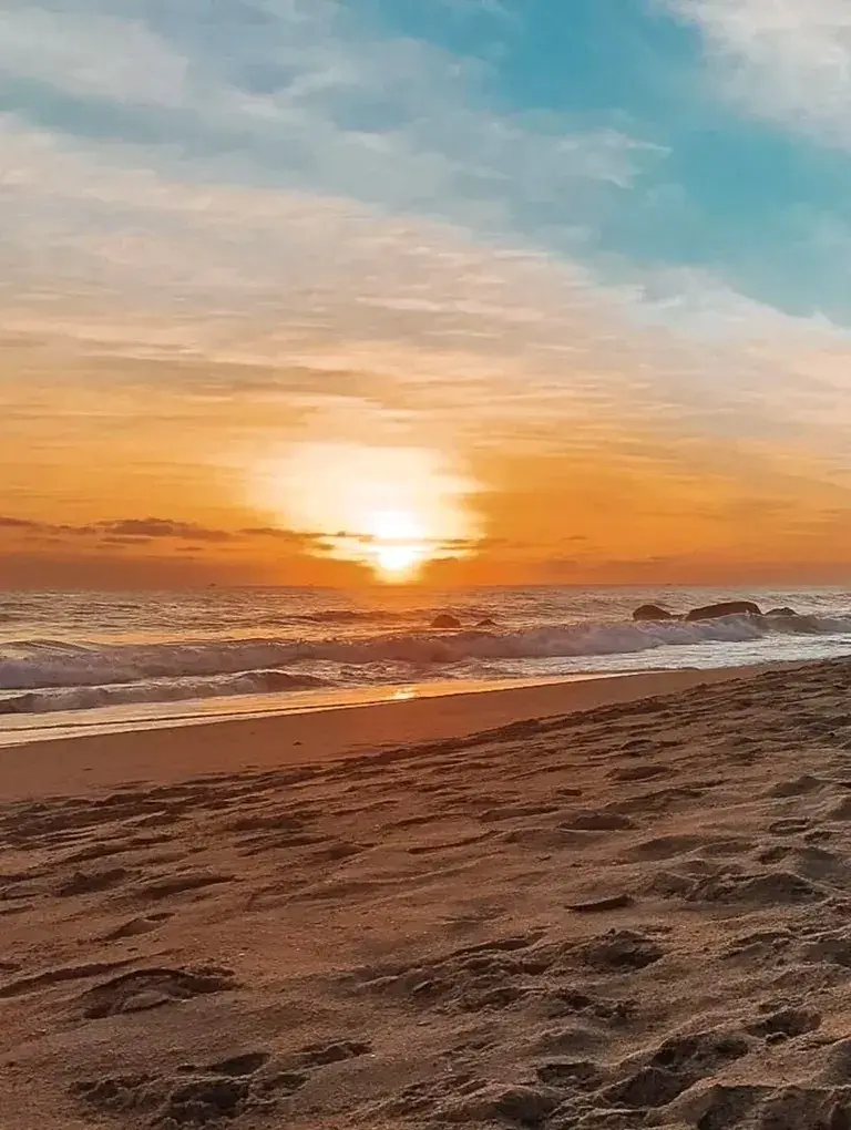 Sunset panorama as amber light softens the shore—an intimate coastal hideaway offering golden-hour serenity for couples in Sayulita.