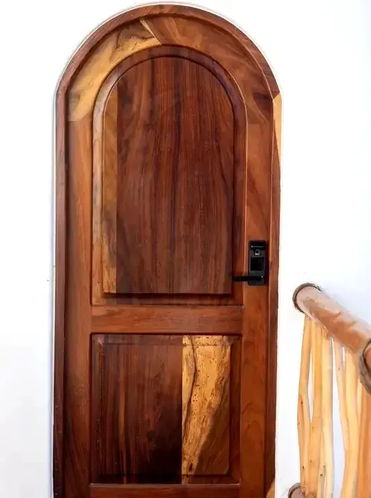 Craftsmen repurpose hurricane-felled Guanacaste into bespoke doors — heritage-crafted design at an upscale eco haven in Sayulita Mexico.