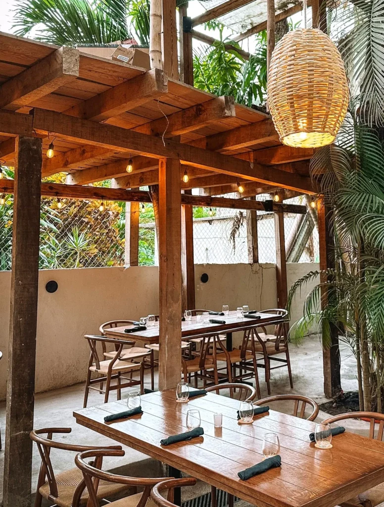Amber light and palm-lined tables set a Mediterranean scene at The Embers — a beloved restaurant in Sayulita