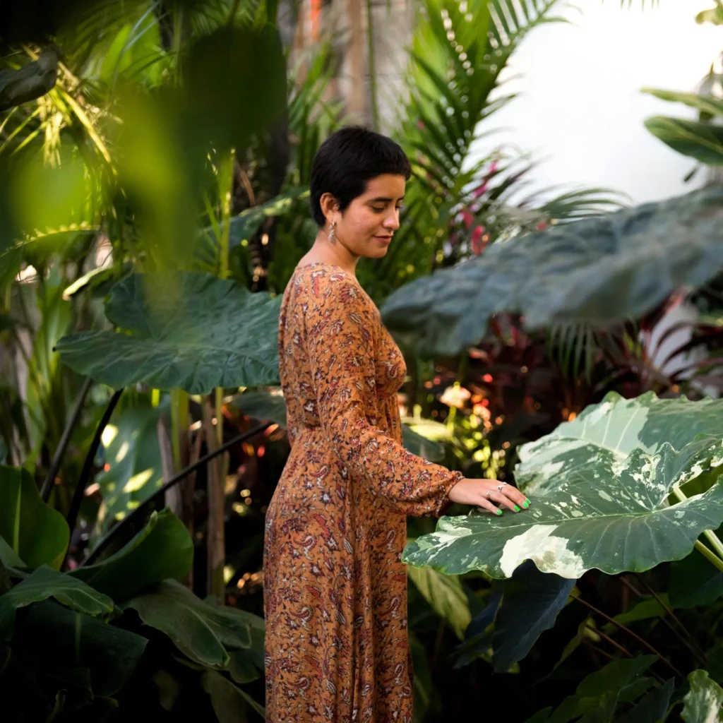 Guest stands beneath a mango tree in Amari’s tropical garden oasis — an untroubled haven of heritage and nature along the Pacific coast.