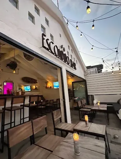 Elegant candlelit patio bar in Sayulita with outdoor tables and an open layout featuring an upscale nighttime feel.