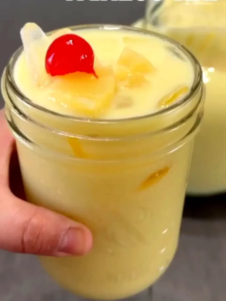A chilled agua fresca in a mason jar with ice and a cherry garnish—an easy market sip along Nayarit’s shores.