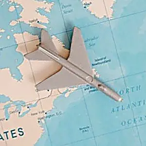 Small airplane model on a world map, representing international travel planning and setting up a phone plan before your trip to Mexico.