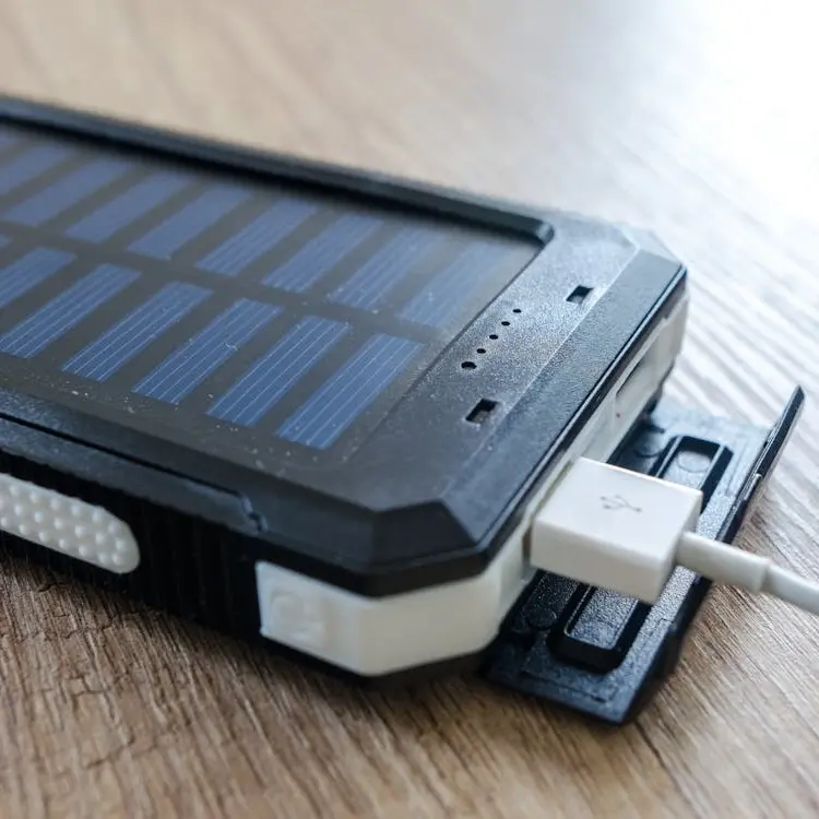 Portable power bank with a charging cable plugged in, a smart way to stay charged during long days out on the West Coast of Mexico (Nayarit).