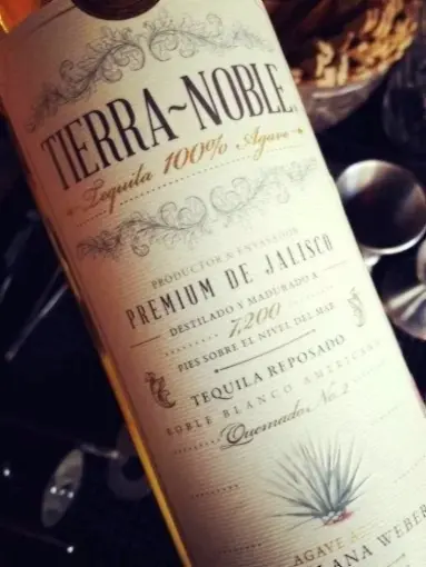 A golden tequila bottle with agave detail glows in warm light, nodding to Jalisco heritage—an iconic pour for sunset hours in Mexico.