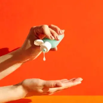 Hand dispensing sanitizer into an open palm against a bright background, a simple must-pack item for day trips and dining out.