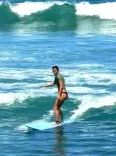 Surfer riding a breaking wave near North Beach along the Riviera Nayarit coastline.