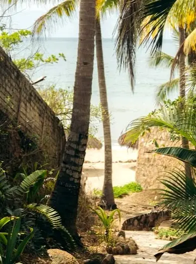 Tropical pathway connecting the North Side neighborhood with Playa Norte and the beach beyond.