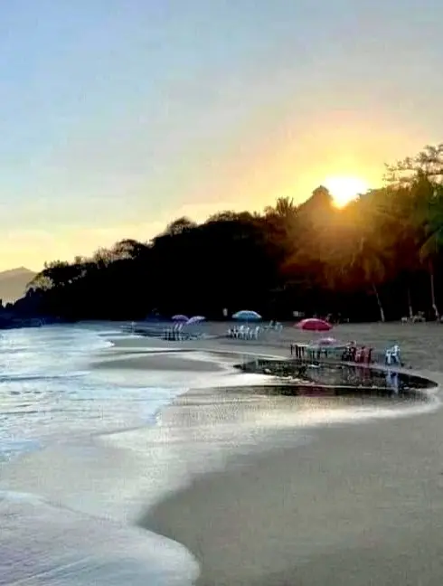 Sunset illuminating the shoreline at Playa de los Muertos along the Pacific coast of Nayarit.