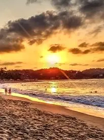 Golden sunset illuminating the shoreline as seen from the North Side beach in Sayulita, Nayarit, Mexico.
