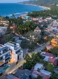 Elevated view overlooking the South Side coastline and hillside neighborhoods near Gringo Hill.