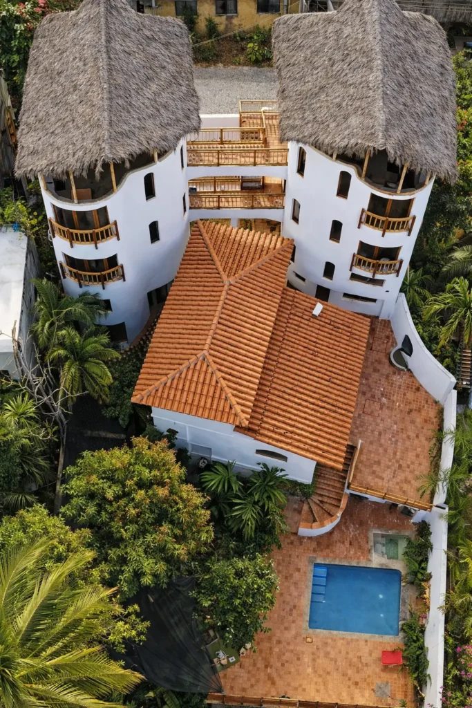 Aerial view of Amari Boutique Hotel's twin palapa towers above the Pacific, Sayulita