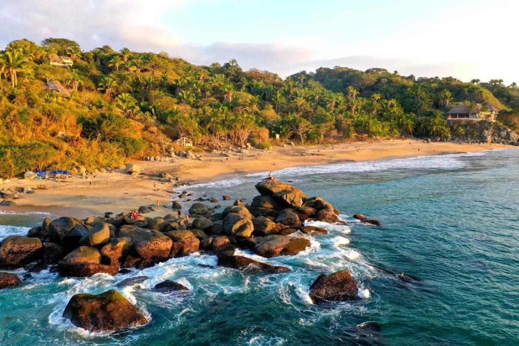 Rocky Riviera Nayarit coastline glowing in warm golden-hour light near Sayulita, Mexico