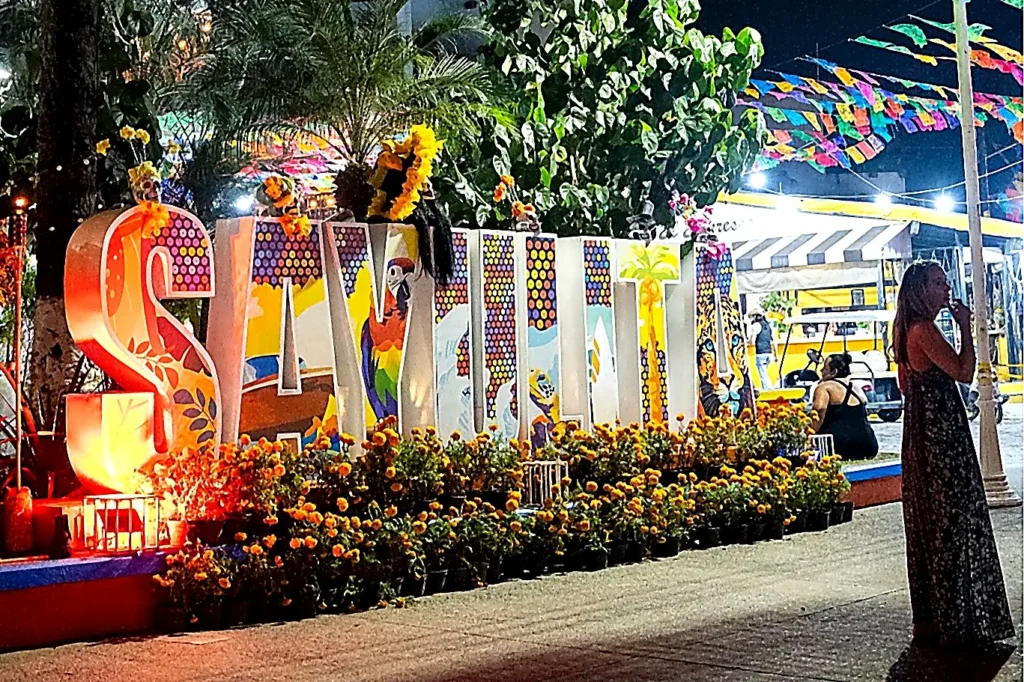 Illuminated Sayulita letters sign glowing in the village plaza after sunset, Nayarit, Mexico