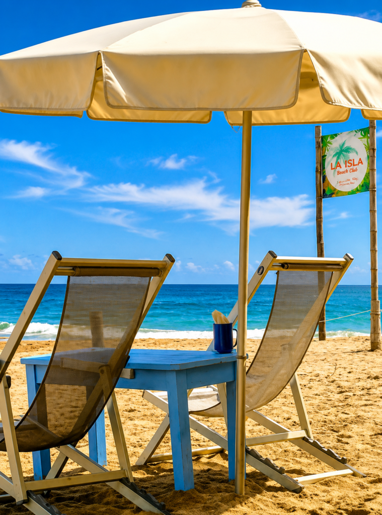 Beach loungers under a sun umbrella facing turquoise Pacific water in Sayulita