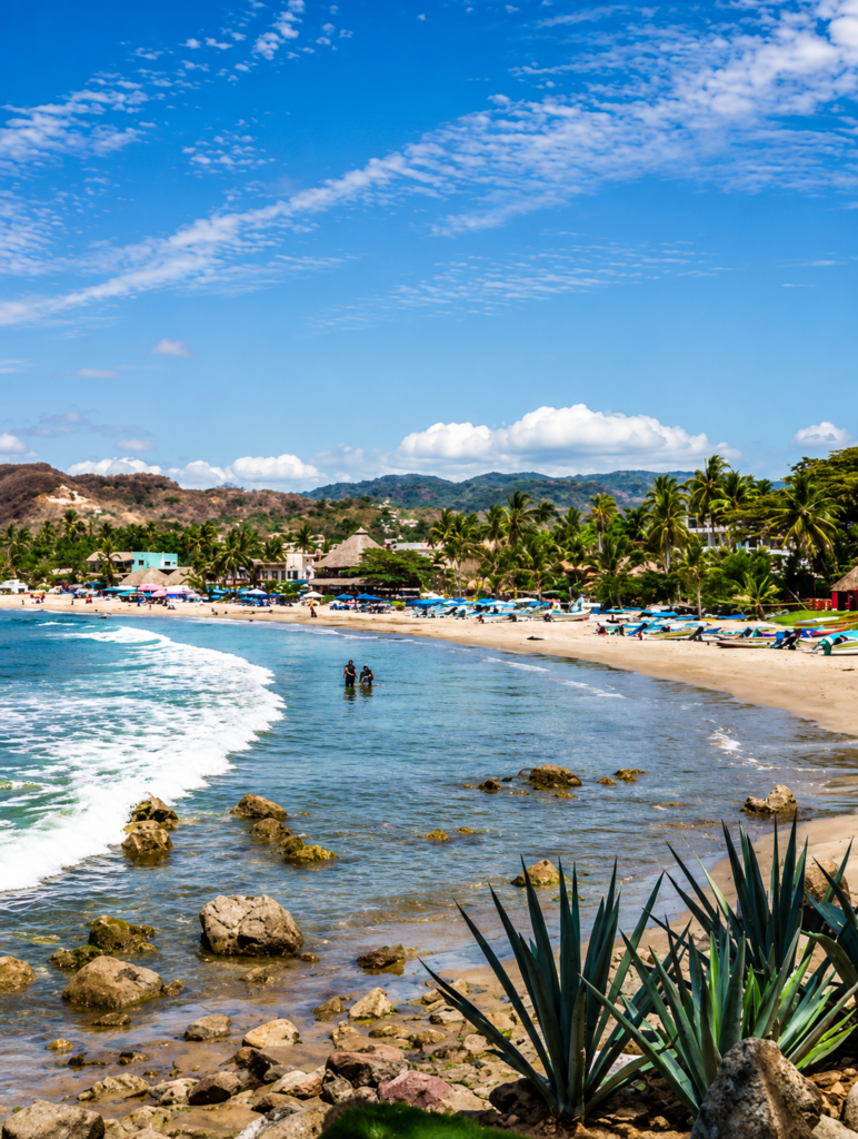 Aerial view of a long Sayulita beach backed by green hills in Nayarit, Mexico